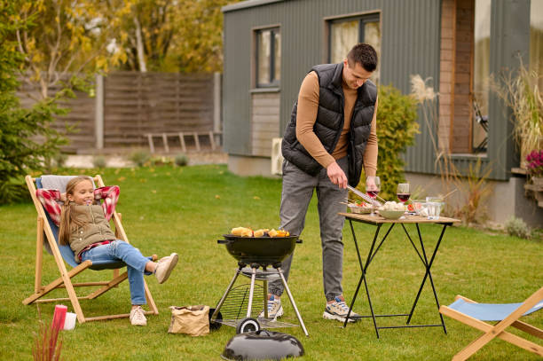 istock Cheerful daughter and her dad having the barbecue party 1420520761