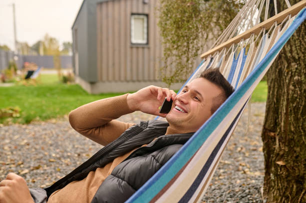 istock Cheerful vacationer talking on his smartphone outside 1420520768