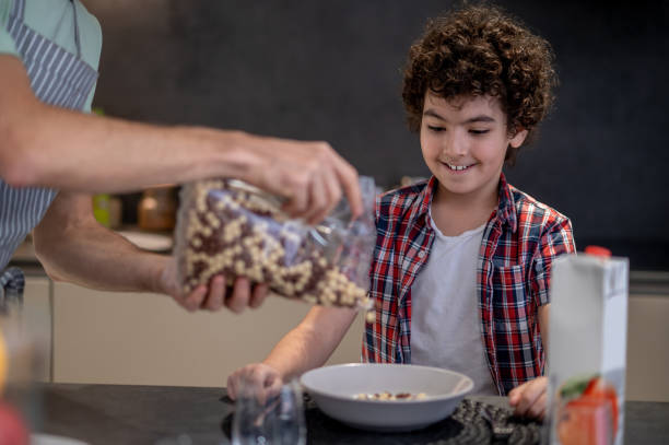 istock Dad preparing breakfast for his son in the kitchen 1420522640