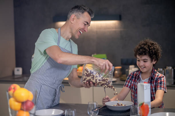 istock Family having breakfast together and looking happy 1420522674
