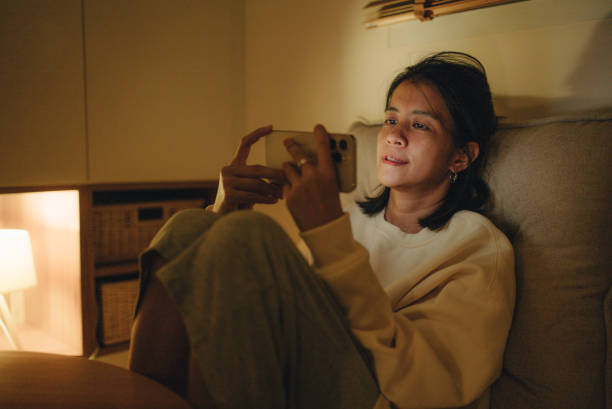 istock Young woman using smart phone in bed 1420529179