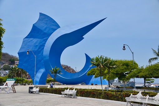 Manzanillo Mexico April 2017 The waterfront park at the cruise pier in Manzanillo Mexico where the main attraction is the Sailfish Sculpture by the Mexican artist Sebastian