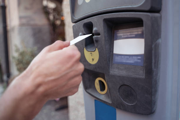 istock Close up of a hand inserting a card to atm 1420534077