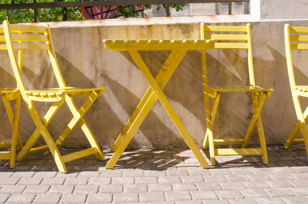 istock Wooden yellow  table and chairs in empty cafe 1420536197