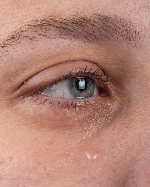 istock eye with a tear flowing down a woman cheek 1420544158