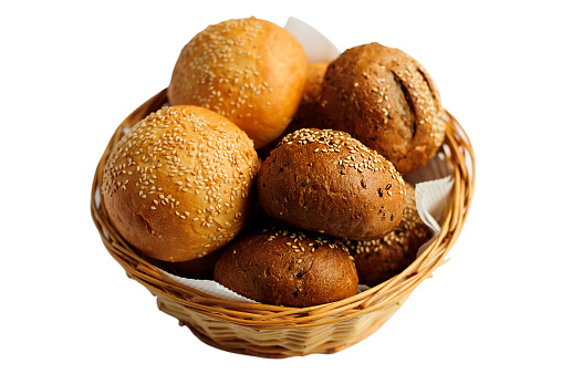 Tasty bread buns with sesame in a basket