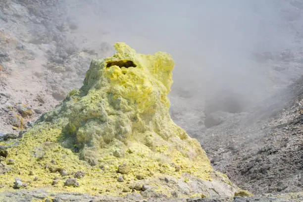 tower of crystallized sulfur around a fumarole on the slope of a volcano