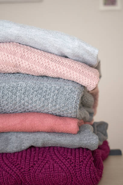 istock Pile of gray and pink wool sweaters 1420551470