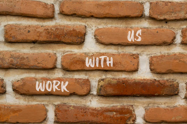 istock Work with us symbol. Concept words Work with us on red bricks on a beautiful brick wall background. Business, motivational and work with us concept. Copy space. 1420556431