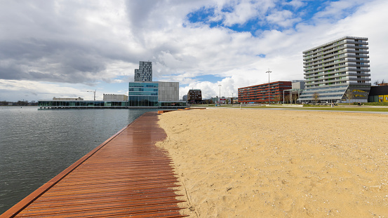Almere, The Netherlands - April 3, 2022: Pier and beach Esplanada Ferry to Floriade Expo 2022 in Almere Amsterdam The Netherlands. Floriade area in the background