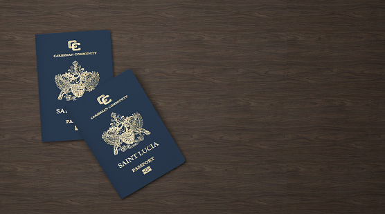 Saint Lucia passport on a wooden board, Citizenship by Investment, close-up