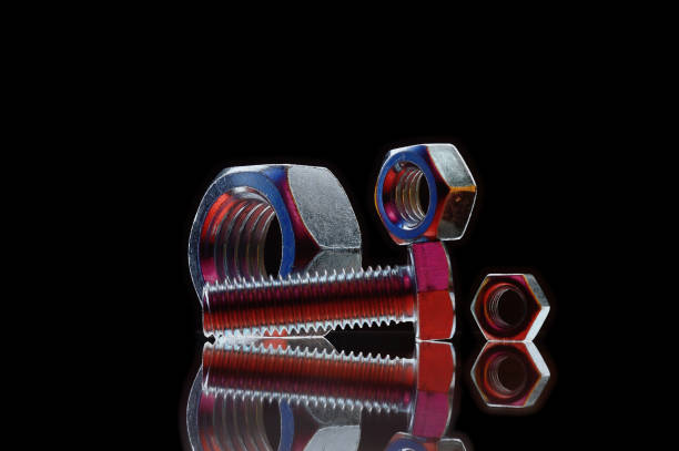 istock composition of bolts and nuts of different sizes on a black background. 1420562009