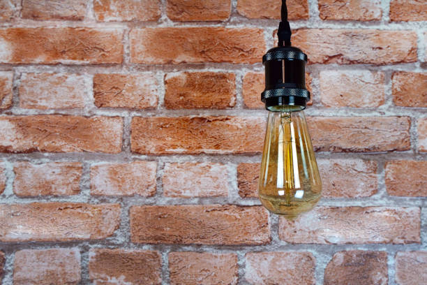 istock Decorative incandescent bulbs in Edison style on a brick wall background. 1420566019
