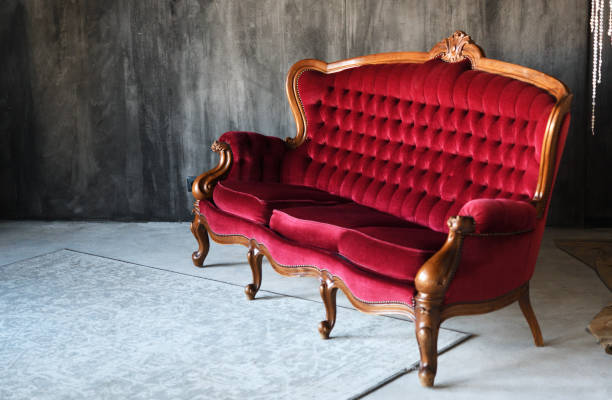 istock Red vintage sofa in the old style against a gray wall. 1420570653