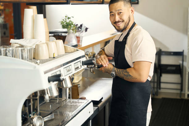 istock Smiling barista doing his work with joy and pride 1420573054