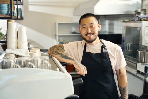 istock Amicable young man posing proudly in his coffee shop 1420573076