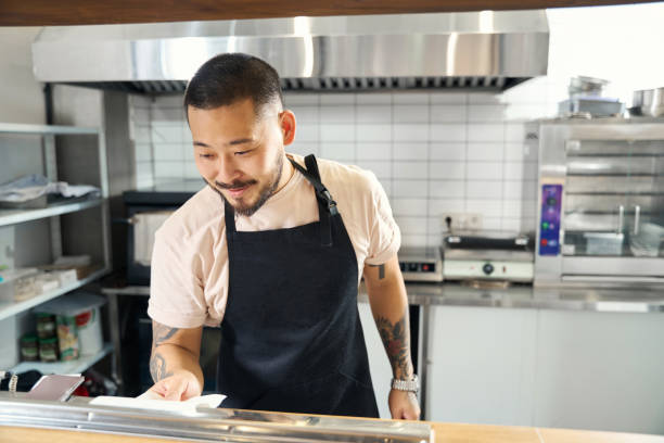istock Radiant young Asian man enjoying his job as restaurant chef 1420573235