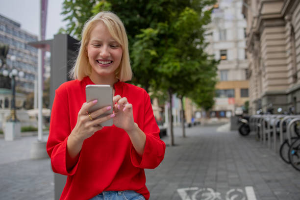 istock Happy young woman using phone 1420577233