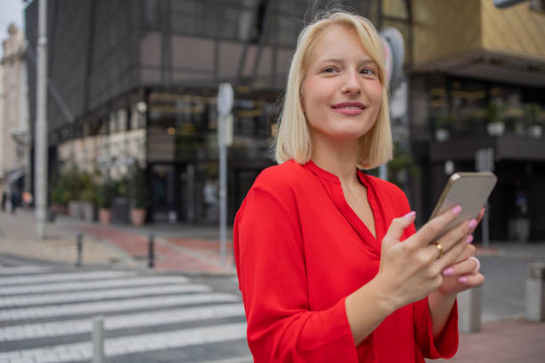 istock Happy young woman using phone 1420577278