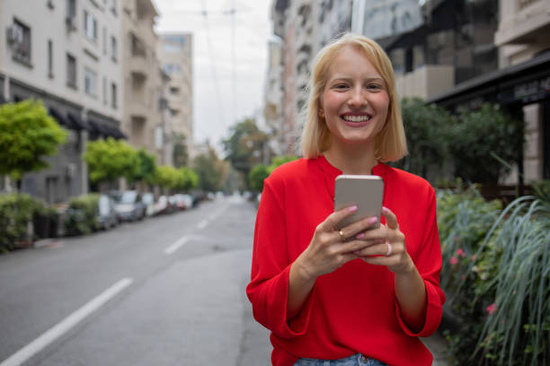 istock Happy young woman using phone 1420577336