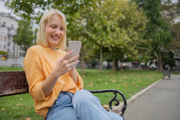 istock Happy young woman using phone 1420577455