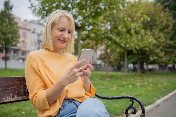 istock Happy young woman using phone 1420577457