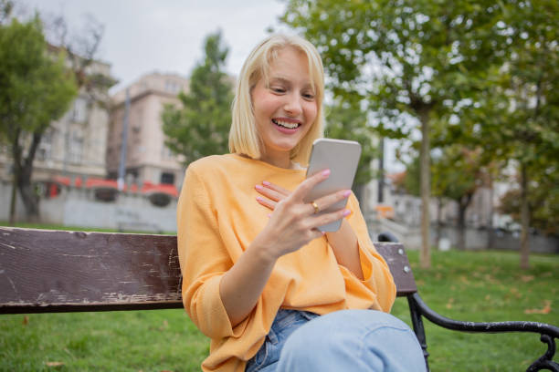 istock Happy young woman using phone 1420577466