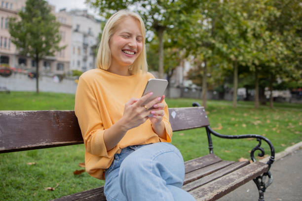 istock Happy young woman using phone 1420577467