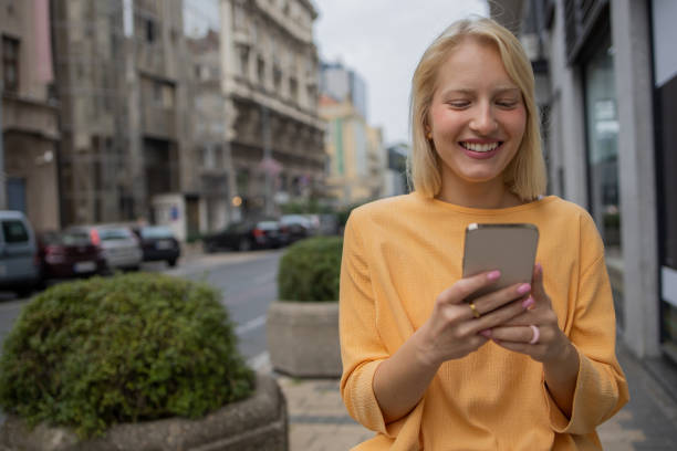 istock Happy young woman using phone 1420577548