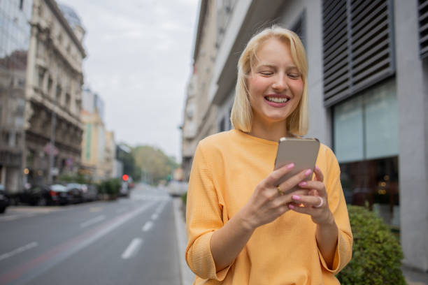 istock Happy young woman using phone 1420577562