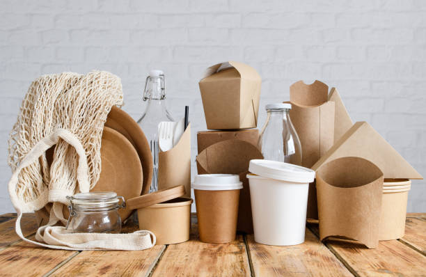 istock Paper and glass eco-friendly tableware and packaging against a light brick wall. The concept of using natural biodegradable materials. 1420581225