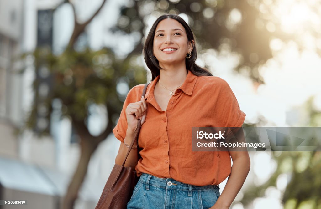 Stylish, happy and trendy student walking in a city, commuting to a college and enjoying a weekend break downtown. Smiling, edgy or funky woman exploring, visiting and enjoying town while sightseeing University Student Stock Photo