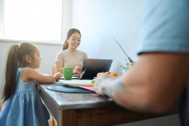 istock Little asian family at the breakfast table 1420585902