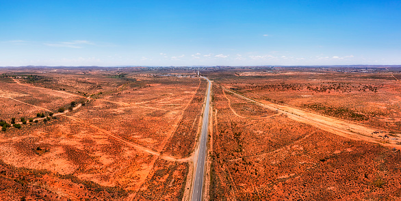 Silver City highway to Broken Hill city through red soil australian outback in short aerial panorama