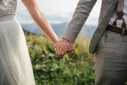 Bride and Groom holding hands during their wedding ceremony