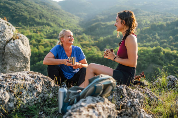 istock Mother and daughter hikers taking a break 1420595069
