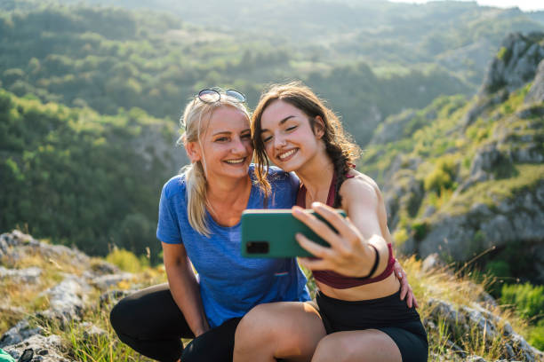 istock Mother and daughter hikers taking a selfie 1420595082
