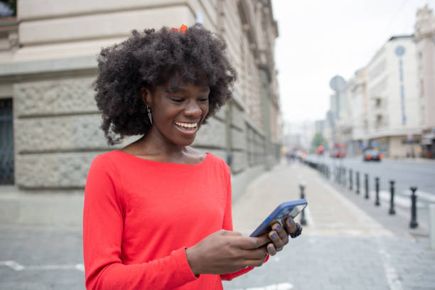 istock Happy young woman using phone 1420595096