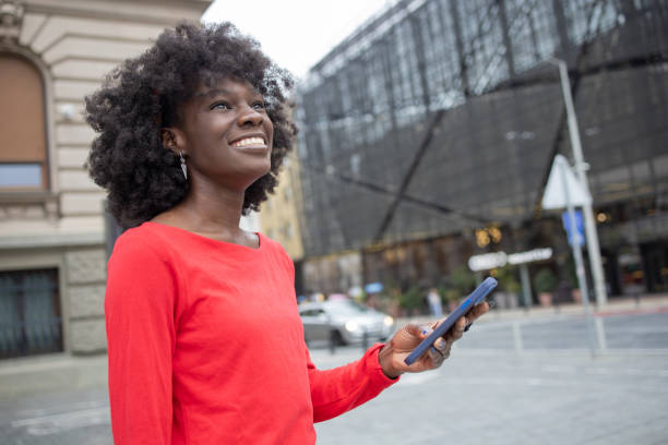 istock Happy young woman using phone 1420595098
