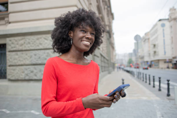 istock Happy young woman using phone 1420595111