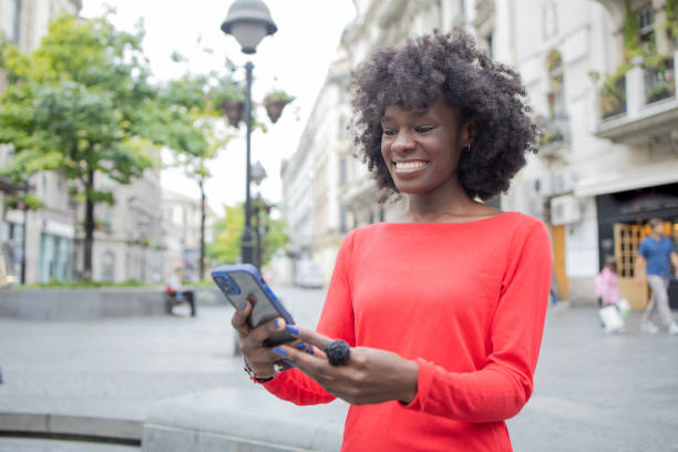 istock Happy young woman using phone 1420595196