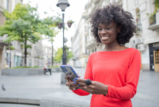 istock Happy young woman using phone 1420595198