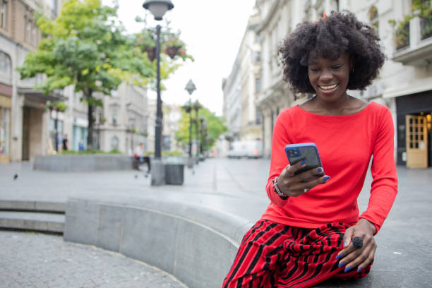 istock Happy young woman using phone 1420595220
