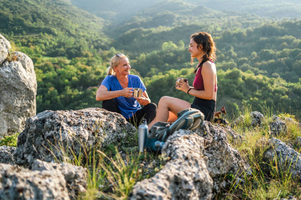 istock Mother and daughter hikers taking a break 1420595230