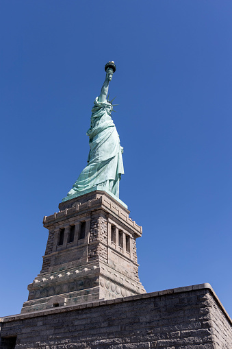 This is a view of the Statue of Liberty from its base. It shows the statue on a clear summer day in New York City.