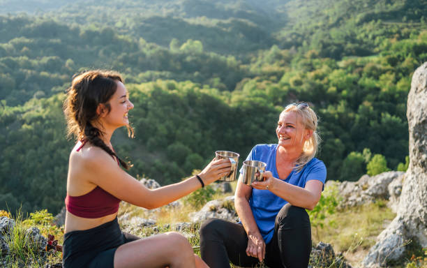 istock Mother and daughter hikers taking a break 1420595600