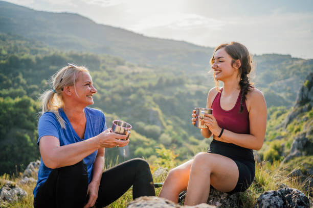 istock Mother and daughter hikers taking a break 1420596261