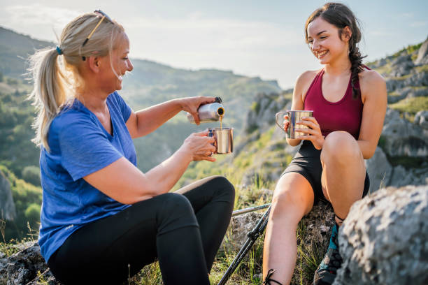 istock Mother and daughter hikers taking a break 1420596286