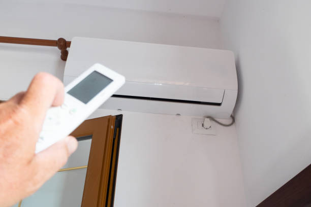 istock A man uses a remote control to adjust the air conditioning. 1420628700