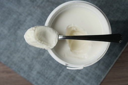 fresh yogurt in a bowl on table .